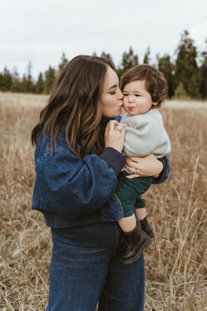 Mom kissing her baby boy gently in a family photo session with Sophie Grace Photography