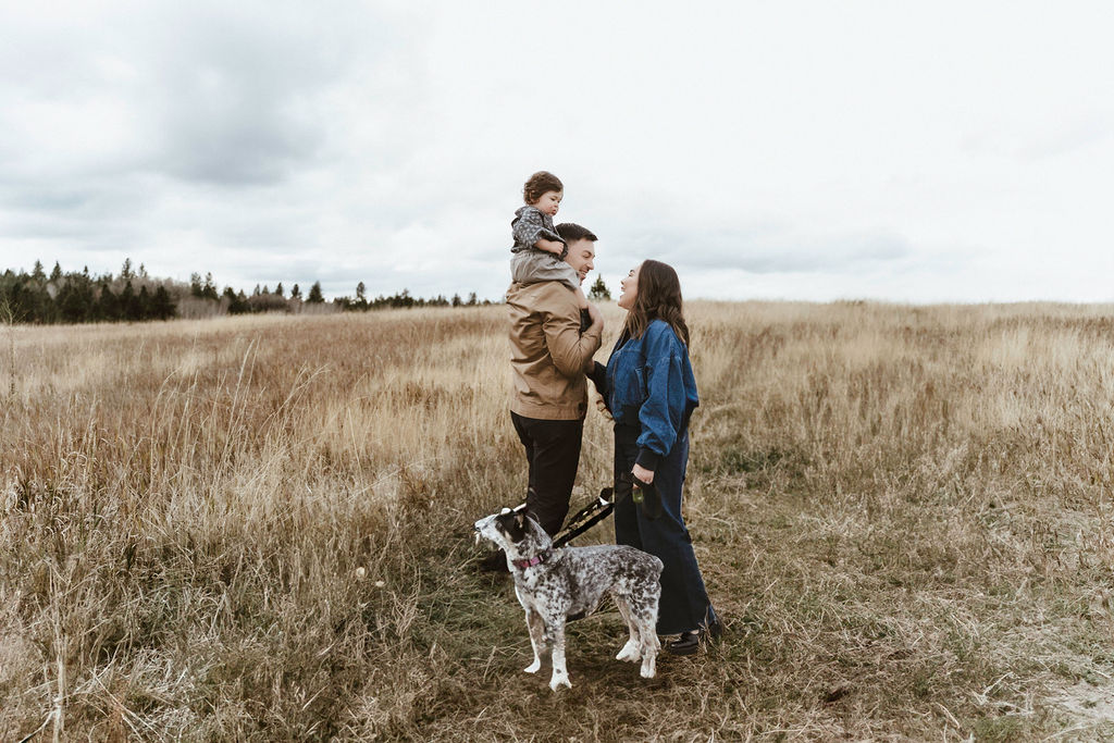 Family of 3 walking their family dog during a spokane family photo session