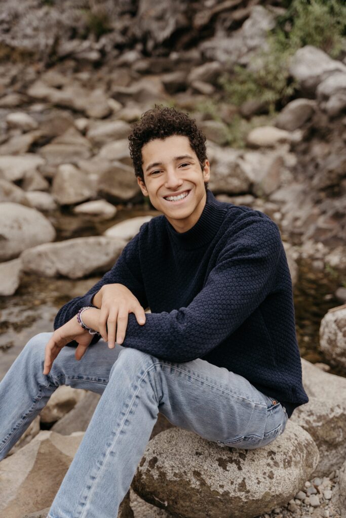 High school senior boy wearing navy sweater for Spokane photoshoot