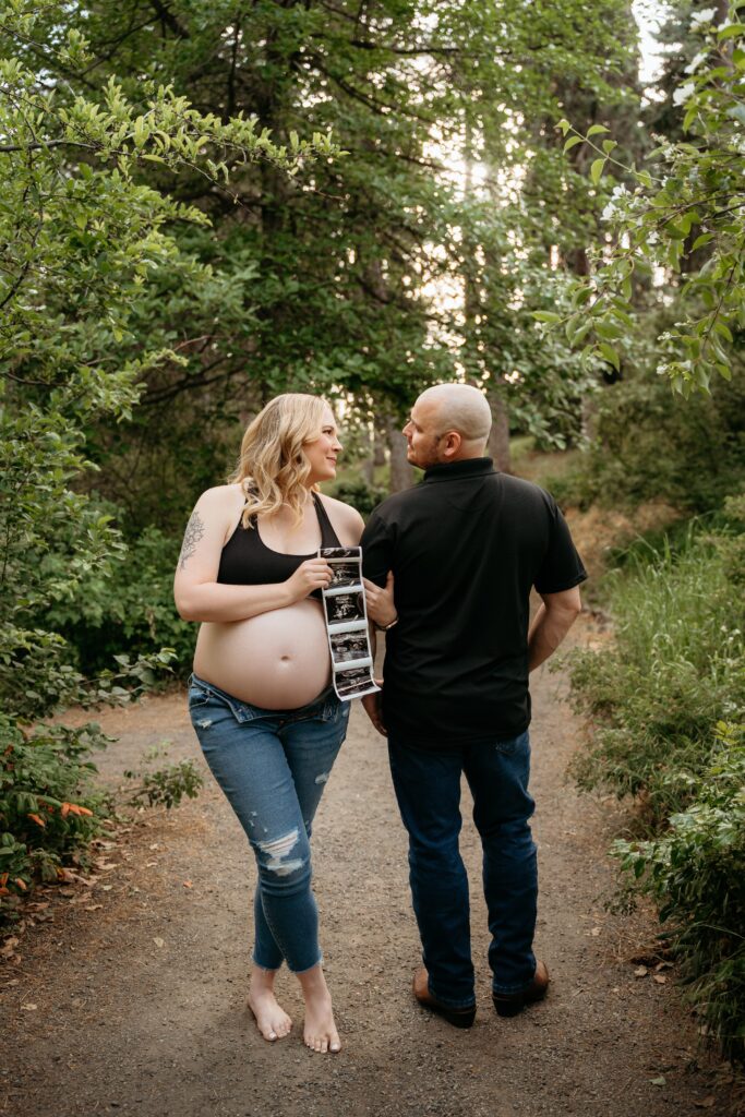 Expecting mom and dad in the park taking maternity photos with Sophie Grace Photography