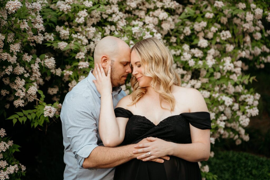 Expecting mom and dad in the park taking maternity photos with Sophie Grace Photography