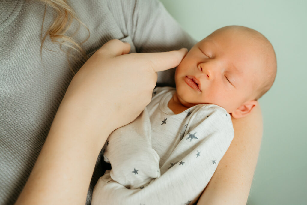 New Parents welcoming their little one during a newborn session with Spokane newborn photographer Sophie Grace Photography