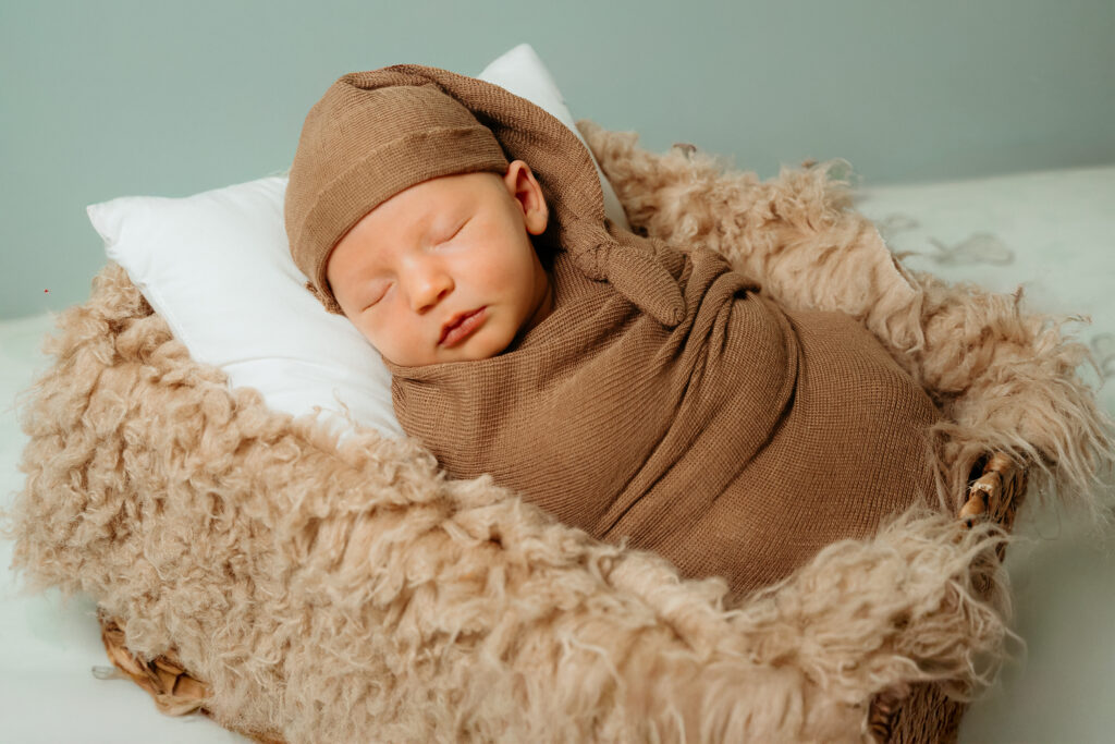 New Parents welcoming their little one during a newborn session with Spokane newborn photographer Sophie Grace Photography