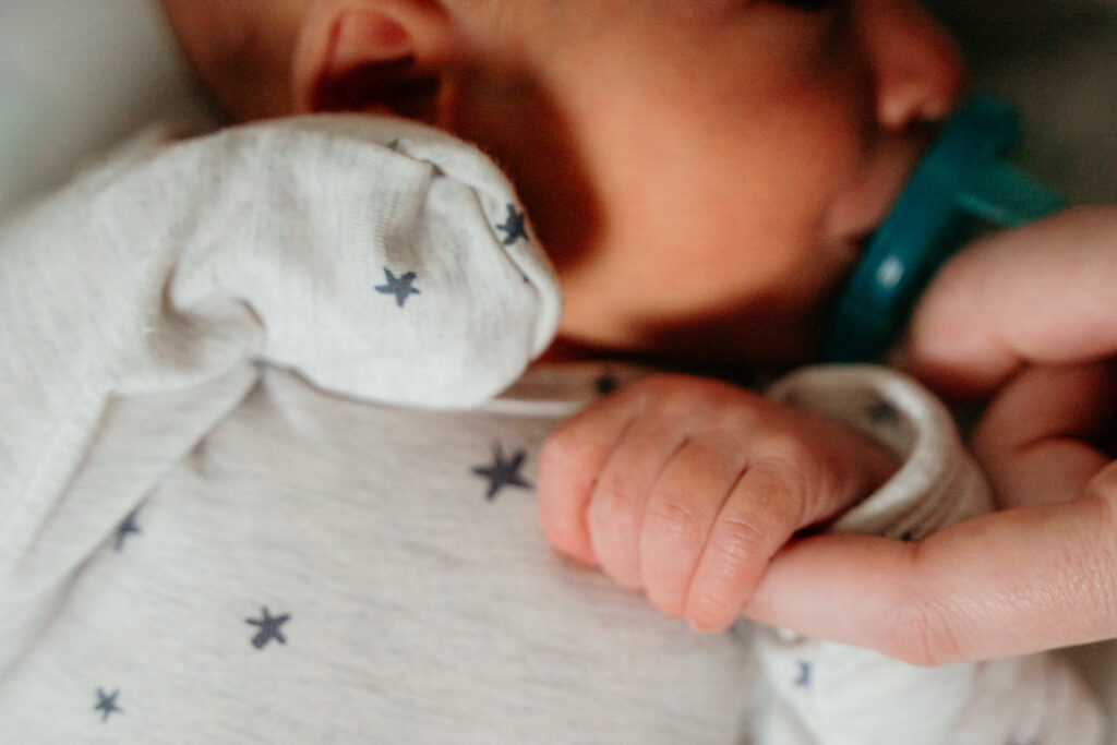 New Parents welcoming their little one during a newborn session with Spokane newborn photographer Sophie Grace Photography