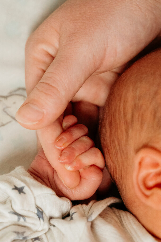 New Parents welcoming their little one during a newborn session with Spokane newborn photographer Sophie Grace Photography