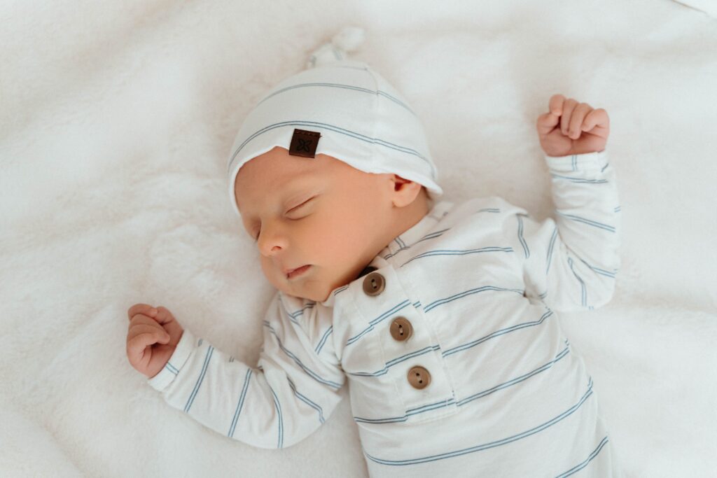 new baby sleeping peacefully in his crib in a relaxing in home newborn session with sophie grace photography in spokane wa