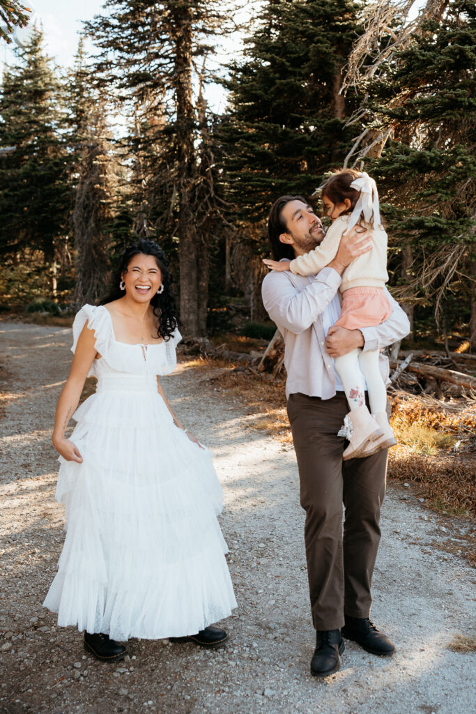 Family laughing together during a fall photo session at Mount Spokane